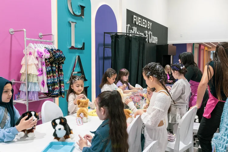 Kids exploring glam salon themed party station