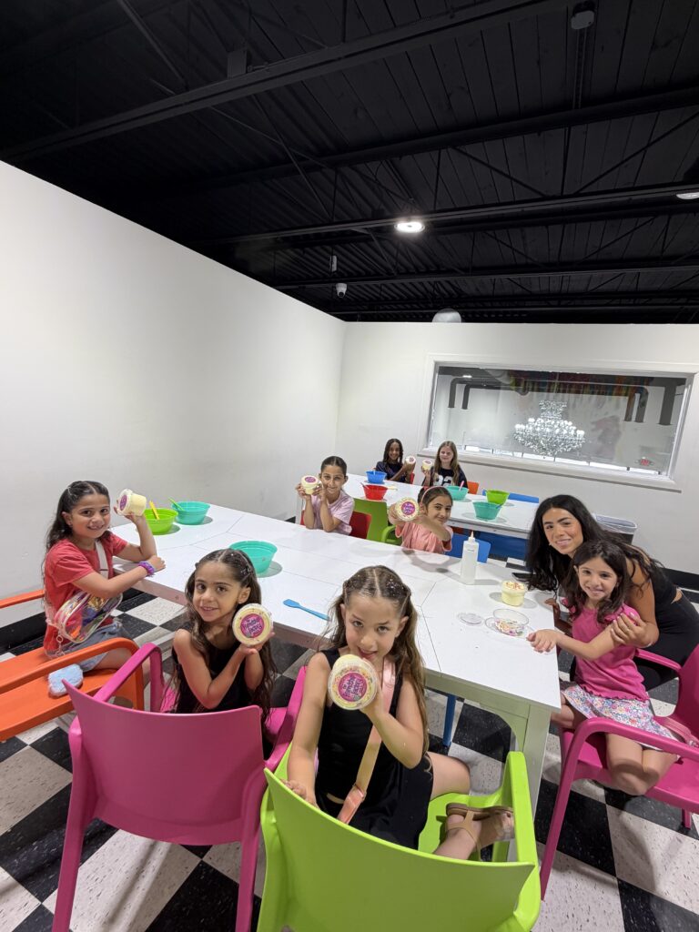 Kids and staff gathered around long party table