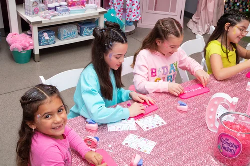 Girls posing with Frozen characters at themed party