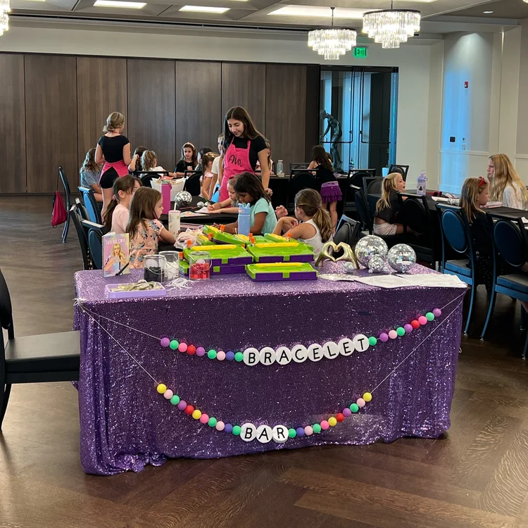 Kids and parents gathered around indoor party table